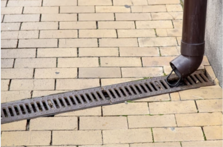Rain gutter, pouring into ground storm drain